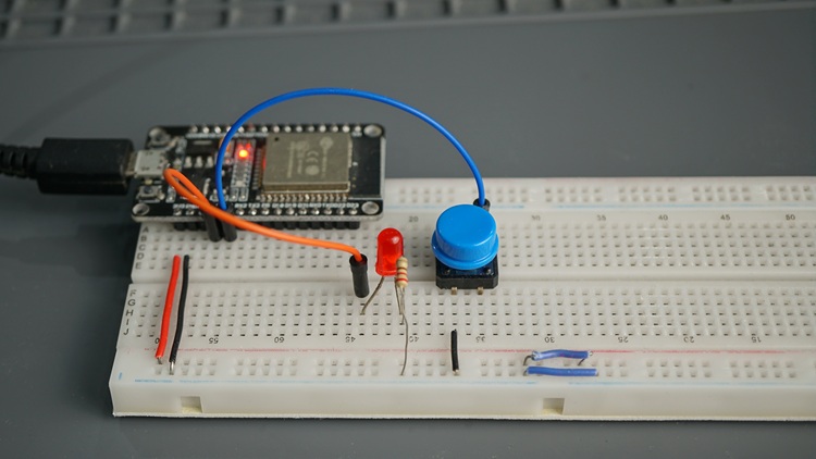ESP32 connected to a pushbutton and an LED to test an example of FreeRTOS one-shot timer