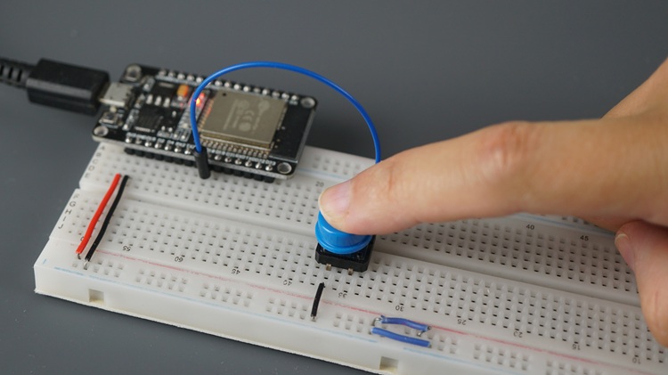Pressing a pushbutton connected to the ESP32